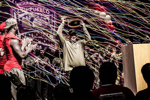 Coach John Wristen presents the championship trophy at the Celebration of Champions pep rally.
Photo by Daniel Potter