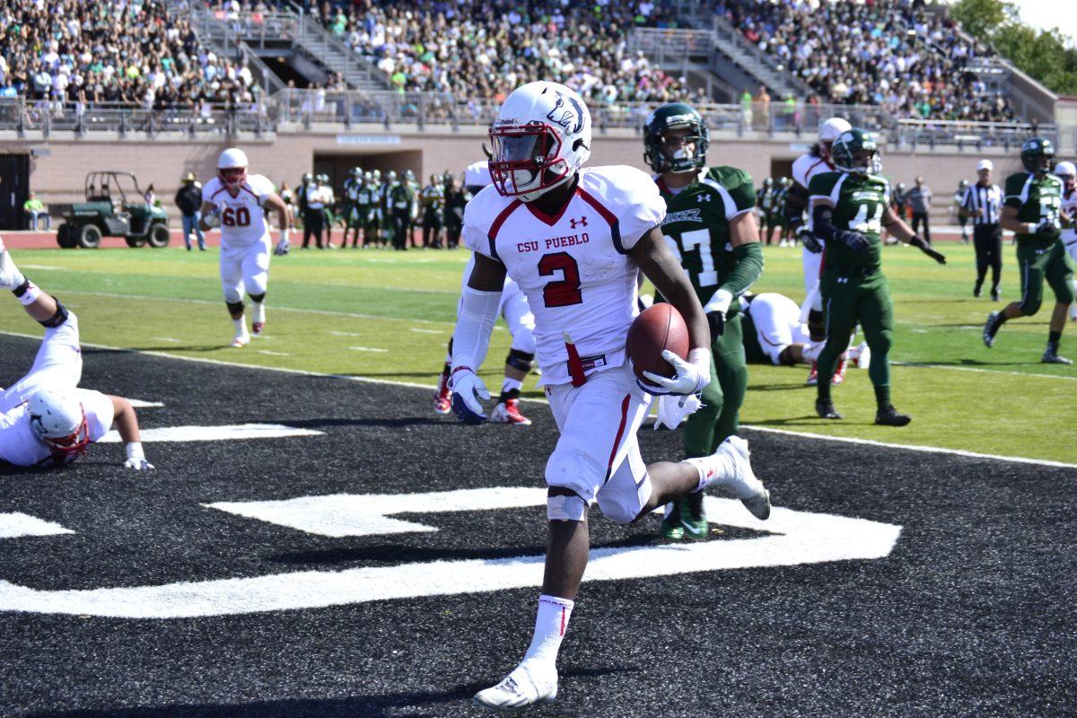 Bernard McDondle runs in for a touchdown against Adams State. Photo by Dustin Cox.