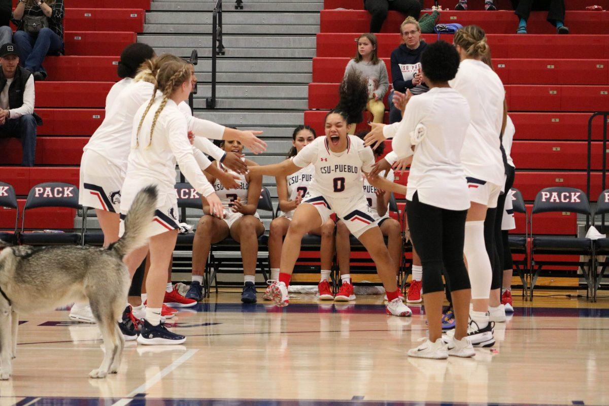 Thunderwolf guard Ro Dominguez (center) slaps fives with the womens basketball team  ahead of a game in this November, 2021, photo [Today photo/Brianna Sammons/file]