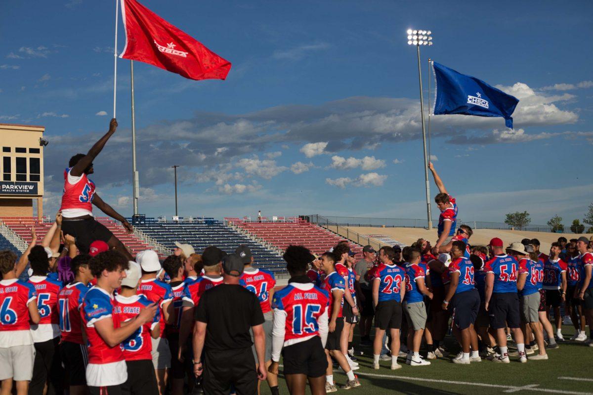 Student athletes raise their team flags, and each other, to signal the start of the 2022 All-State Games. [Today photo/Kimmy Reinhardt]