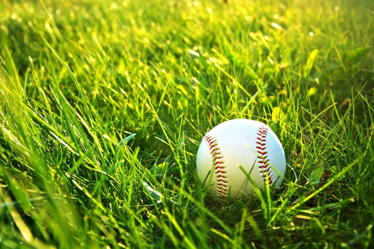Baseball+game.+Baseball+ball+in+grass.