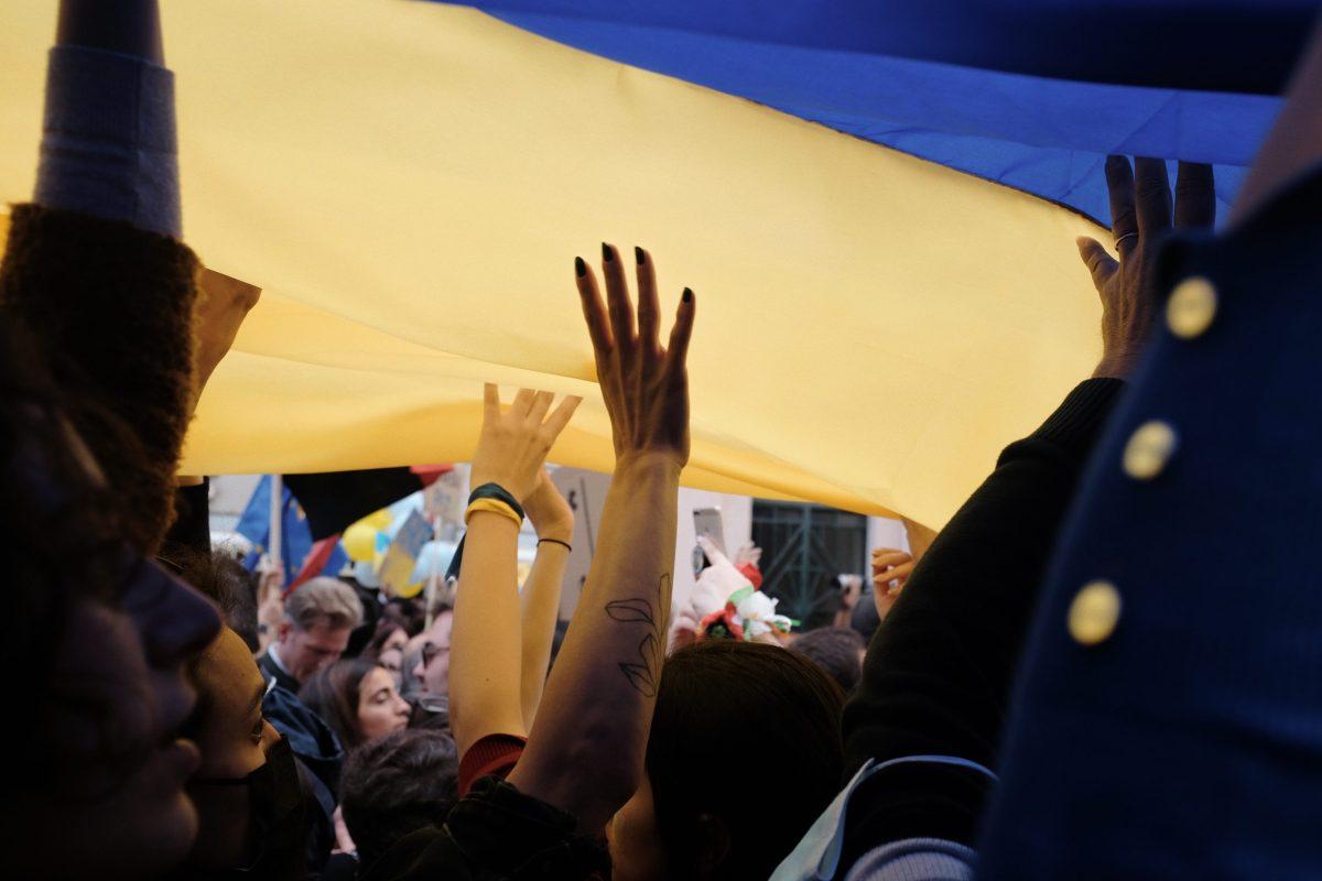 Photo+provided+by+Unsplash.+People+holding+up+the+Ukraine+flag.