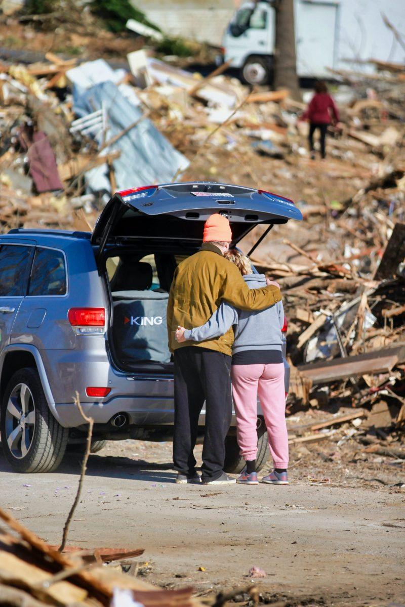 A couple amid the ruins of a tornado zone. Photo provided by Unsplash.