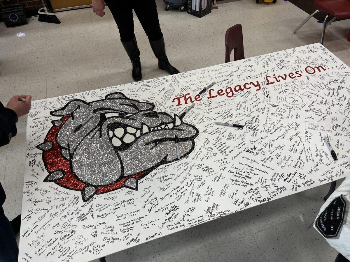Centennial alumni were encouraged to sign their name and graduation year on a memory board titled The Legacy Lives On… Photo by Holly Ward. 