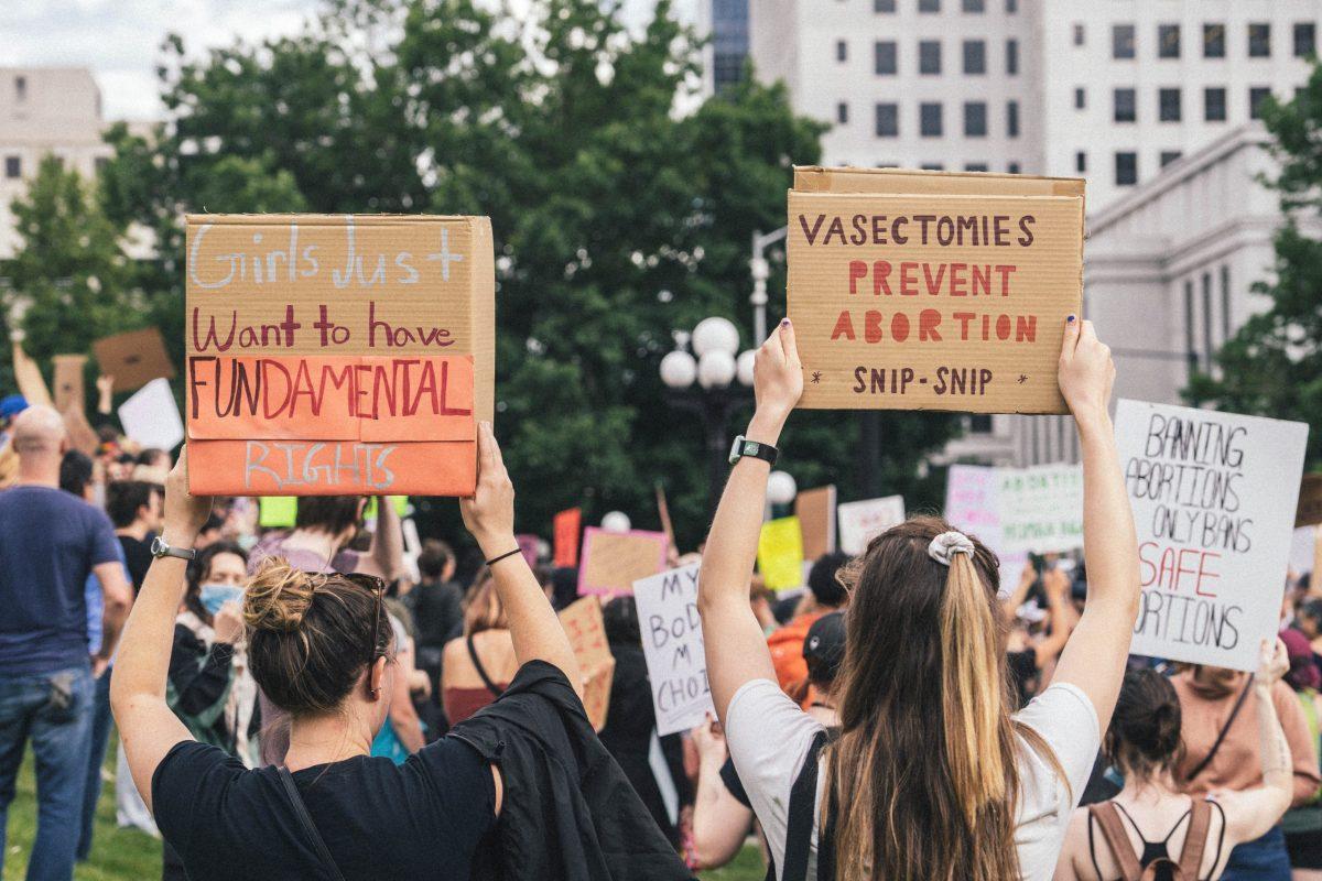 Signs held at abortion protests in Denver, CO, after U.S. Supreme Court overturned Roe v. Wade in 2022. Photo provided by Unsplash, Jack Prommel. 