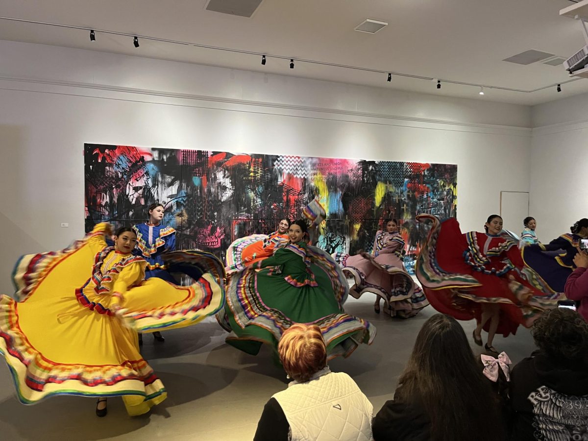 Performers from Ballet Folklorico danced in front of Deal’s largest painting on display during the opening night for the Red Mirror exhibition.