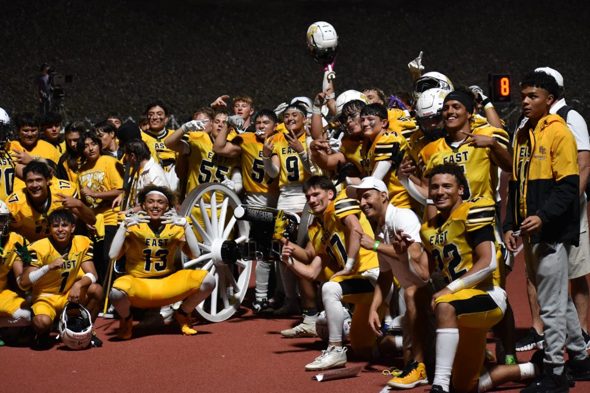 The Pueblo East Eagles surround the cannon trophy after beating Pueblo South 21-15.