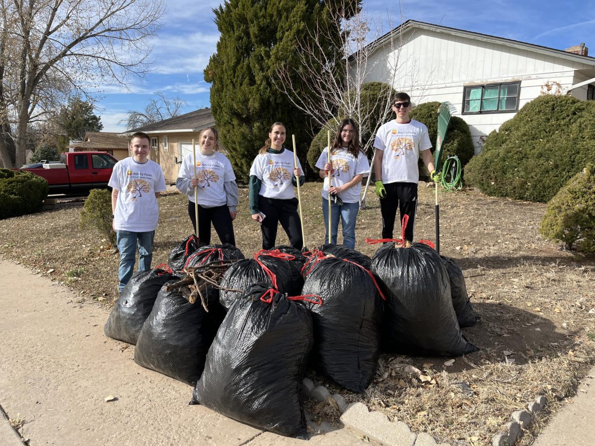 A group of students from CSU Pueblo’s Circle K stand behind the bags of leaves they gathered as part of the annual Rake Up Pueblo community service event. (Photo by Holly Ward)
