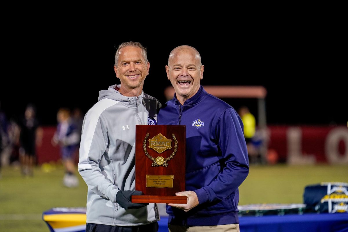 Head coach Oliver Twelvetrees (left) is shown holding the team’s 2024 RMAC regular season title pregame of their RMAC Tournament Championship match over Fort Lewis. (Photo captured by Jayson Ortiz)
