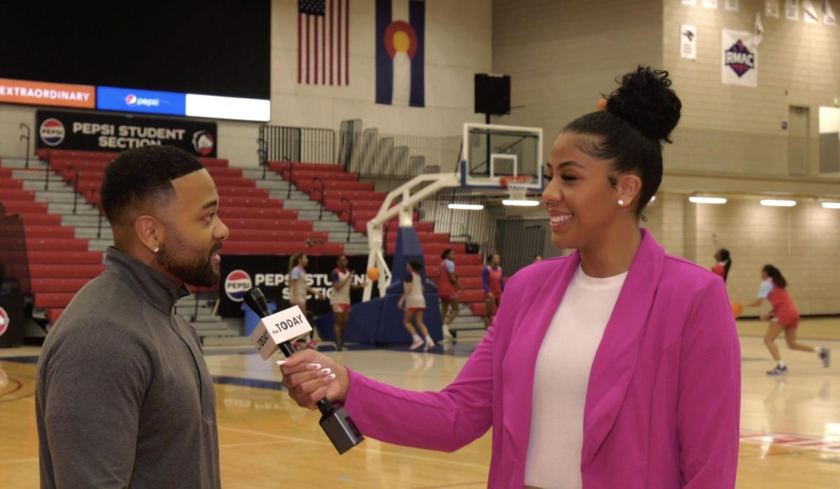 The Today reporter (right) interviews Jalen Little (left), assistant women’s basketball coach.