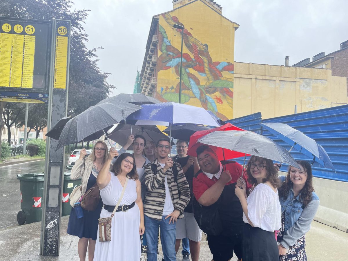 Students gather under umbrellas during a study abroad trip. (Photo courtesy of Chris Picicci).