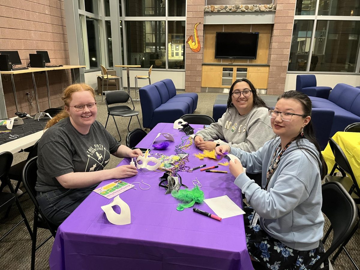 Students decorate masks at the Mardi Gras Activity Parade. (Photo by Holly Ward)