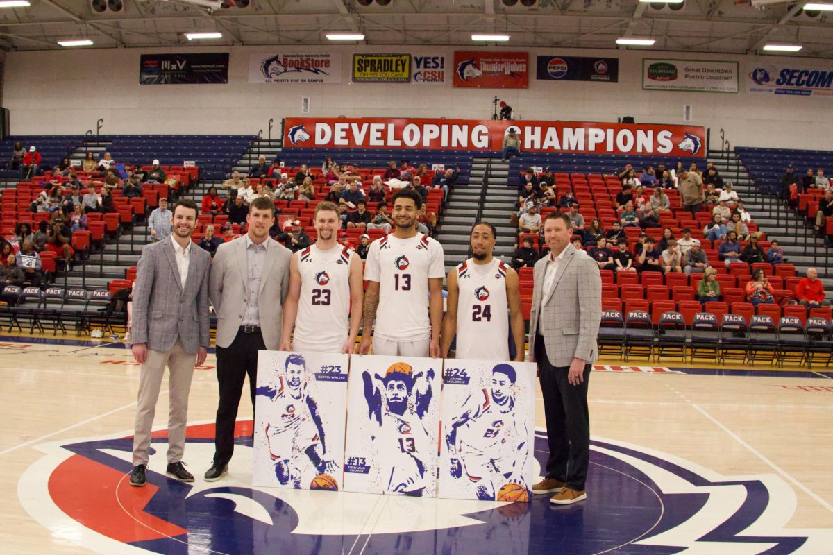 Senior players Brevin Walter, Armon Muldrew and De’Shaun Cooper are shown standing with the men's basketball coaching staff at center court during the team’s senior day ceremony, which took place on Saturday, March 1 at Massari Arena. (Photo by Scott Mills) 