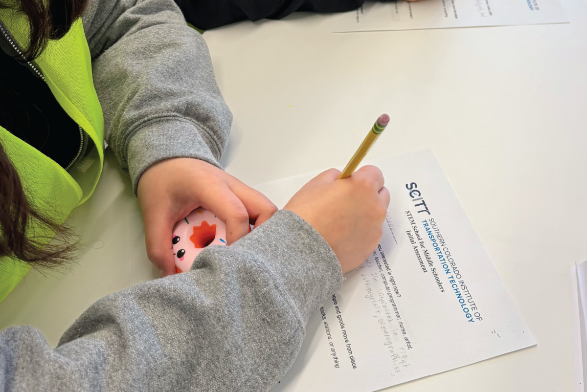  Photo of Friday STEM class middle schooler writing (Photo by Ashley Hughes).