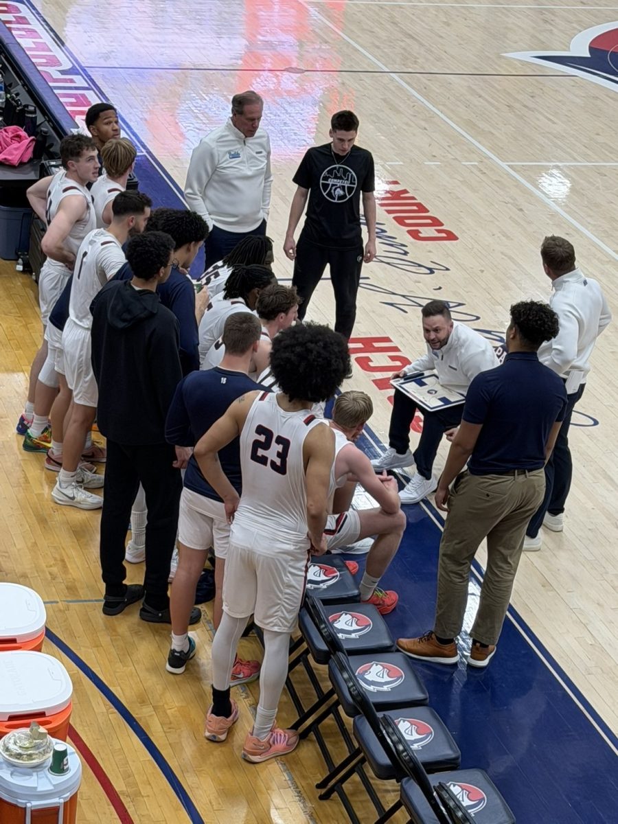 Coach Ruebesam debriefing his players in the middle of the 4th quarter (Photo by Gio Alfonso).
