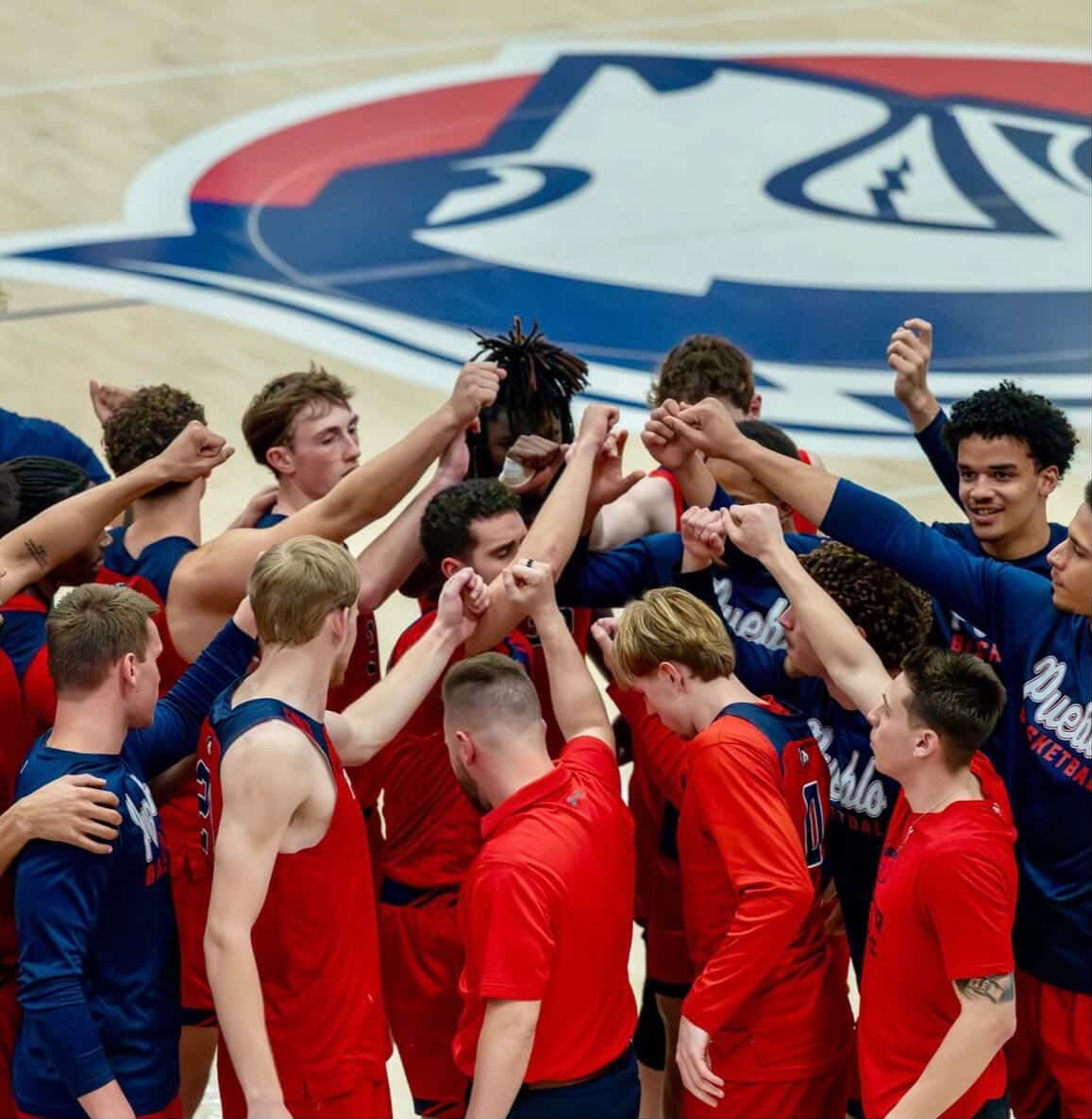 The Pack breaking a huddle during one of their games (photo by John Feil).